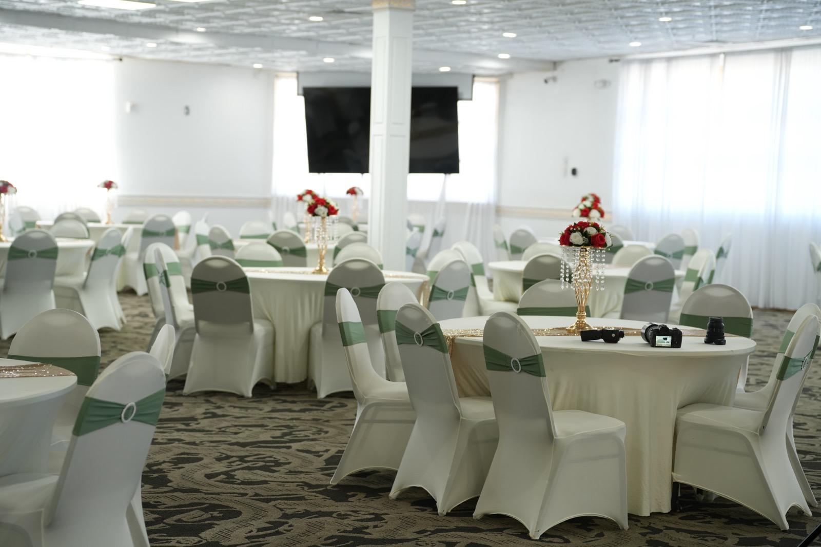 Elegant banquet decor with sage-green accents and rose crystal centerpieces